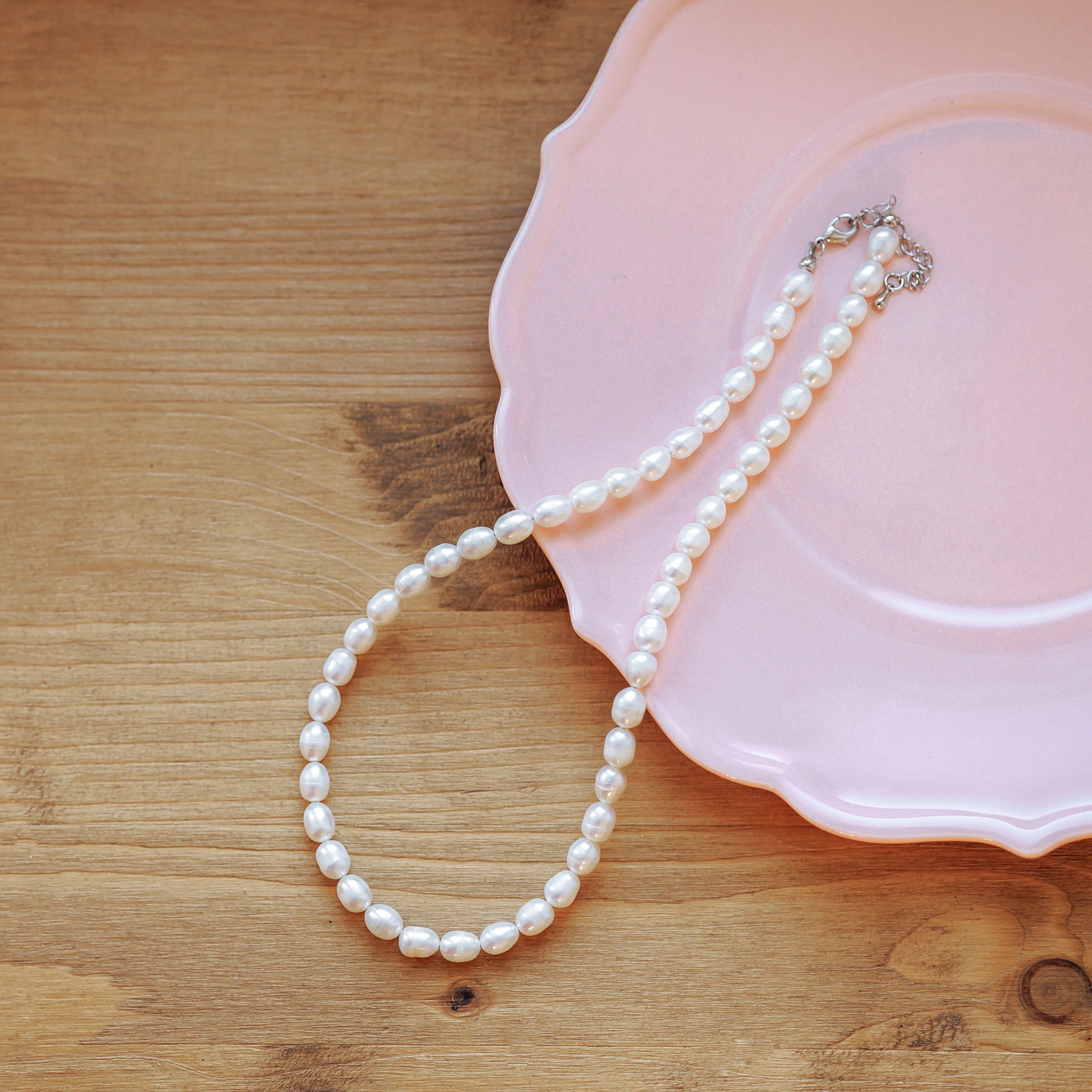 Elegant jewelry flat lay with pearls and soft natural styling